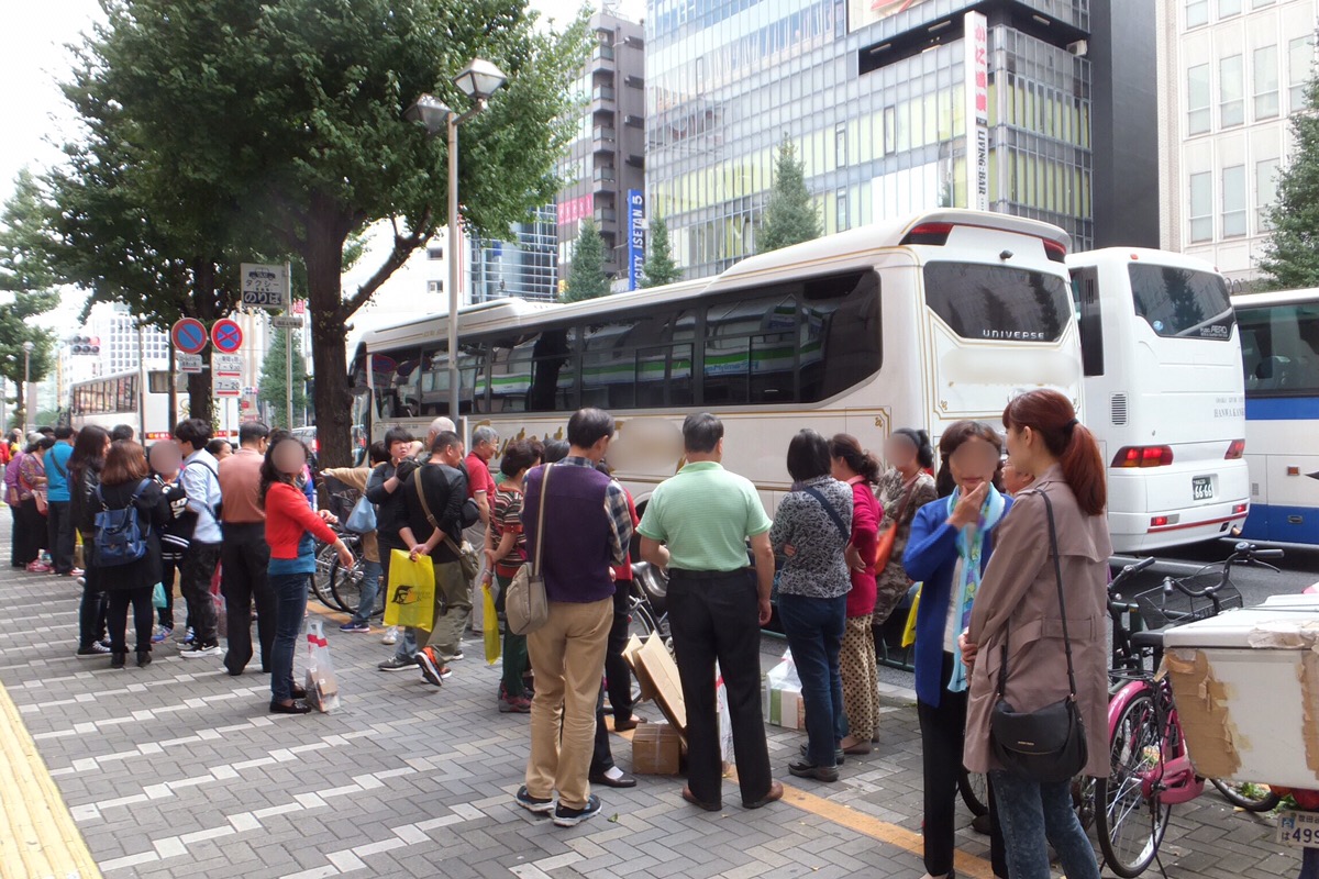 tour group boarding a tour bus in japan